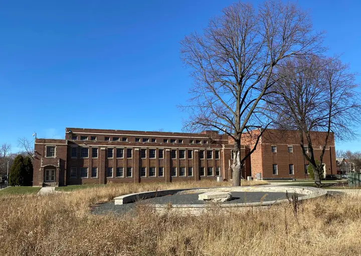 The gymnasium from the side; exposes a more red-toned brick on the expanded portion on the right.
