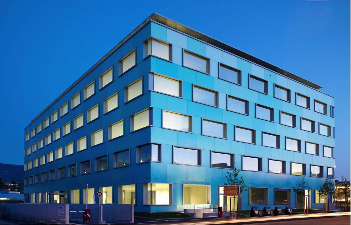 Picture of ProtonMail's 5 story teal office building in Geneva.