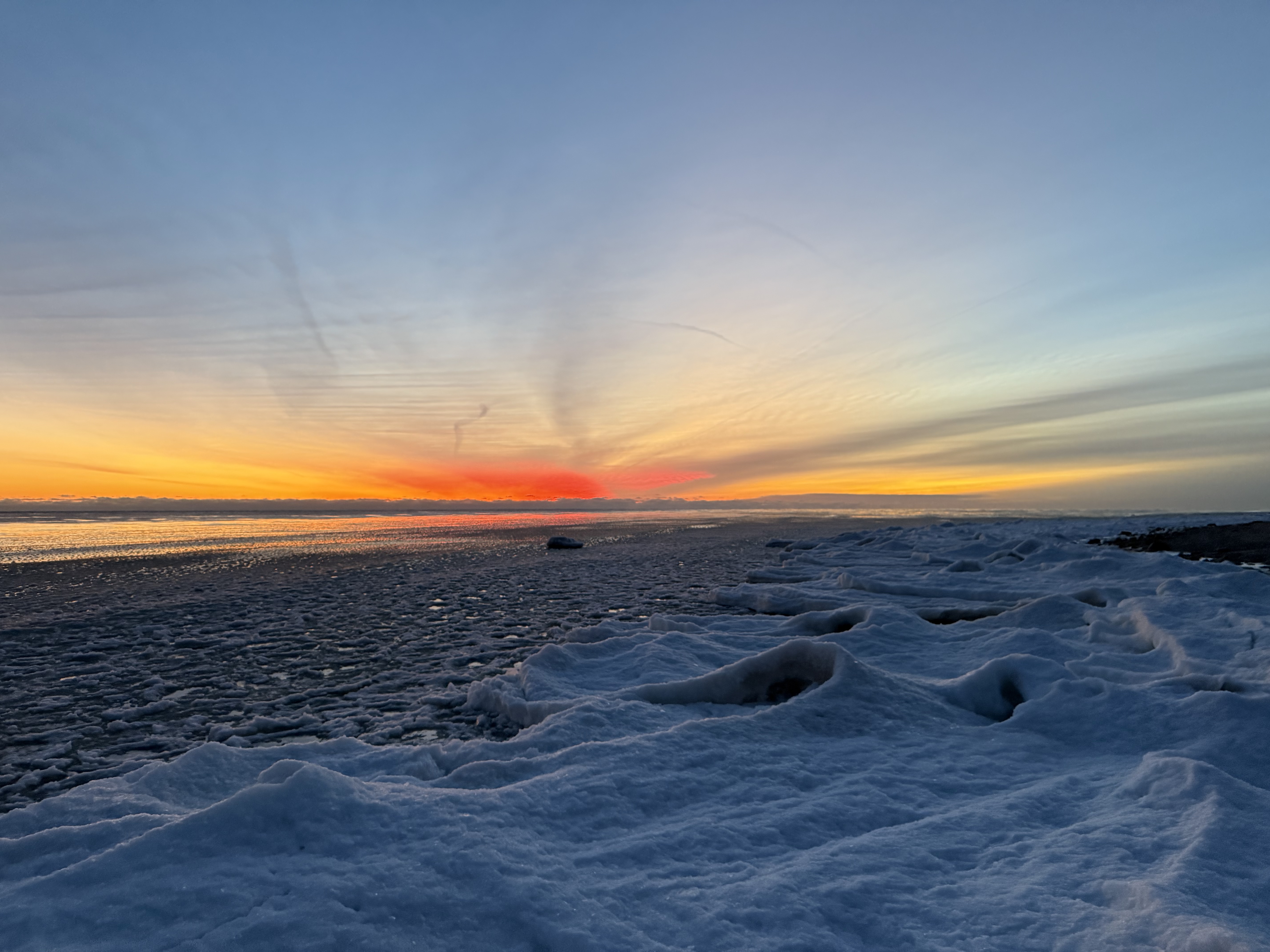 Sunrise over an icy Lake Michigan.