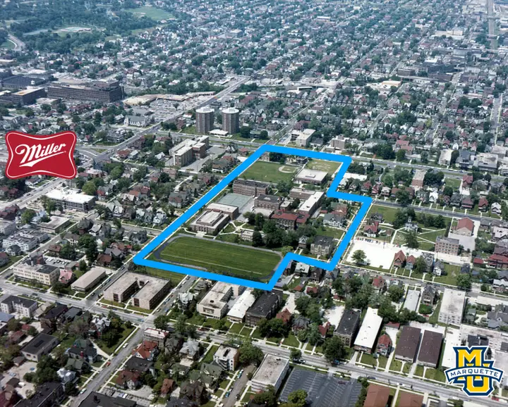 An aerial view from the 70's with an outline around the campus boundaries and the Miller Brewing logo on the left; Marquette logo on the right.