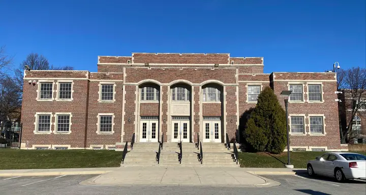 Same building today looking straight on. A parking lot is visible in front.