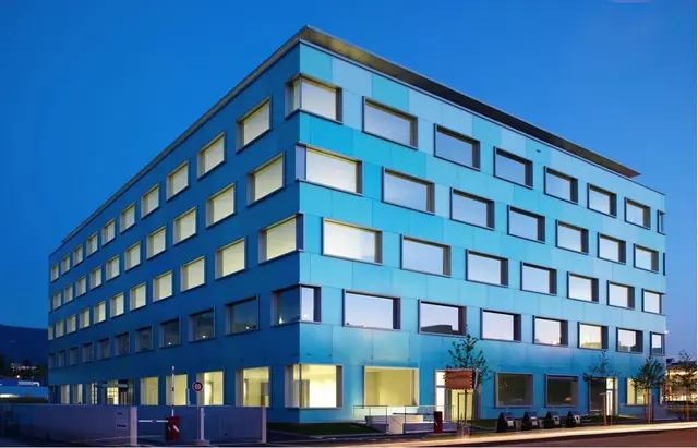 Picture of ProtonMail's 5 story teal office building in Geneva.